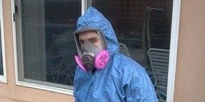 Mold Cleanup Technician In Full Gea At Job Site