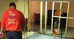 water-damage-restoration-technicians-cleaning-carpet-after-a-flood